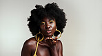 Black woman fashion model blow kiss for beauty, makeup and African empowerment in skincare and afro hair. Headshot portrait of creative young Nigeria girl or happy black person in studio background