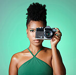 Black woman, photographer or fashion model on green studio background in creative art, clothes brand or designer social media blog. Portrait, camera and digital photography person with cool hairstyle
