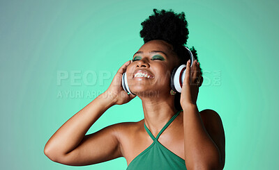 Buy stock photo Studio, happy and black woman in headphones with music playing from a Jamaican dance hall and reggae radio audio playlist. Freedom and young African girl enjoying listening fun, streaming and sounds