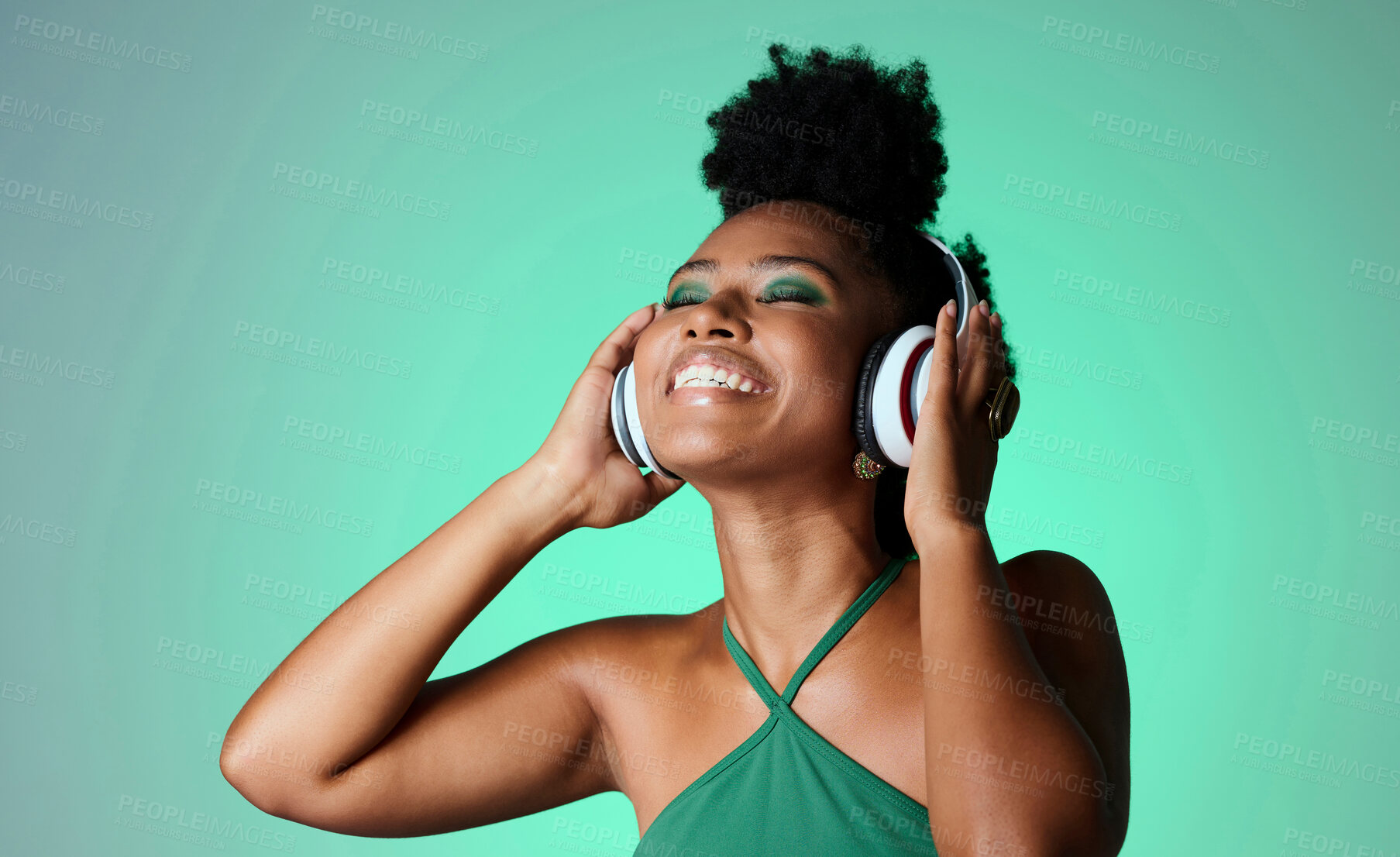 Buy stock photo Studio, happy and black woman in headphones with music playing from a Jamaican dance hall and reggae radio audio playlist. Freedom and young African girl enjoying listening fun, streaming and sounds