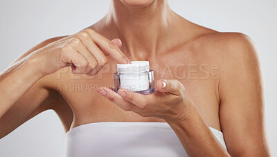 Buy stock photo Cream, beauty skincare and hands of woman with product for body wellness against a grey studio background. Spa model with natural and organic lotion in container for clean body and dermatology health