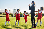 Fitness soccer, girl team and stretching with sport coach on sports field training, exercise or workout. Children, kids or  coaching in diversity, teamwork and collaboration on motivation for game.
