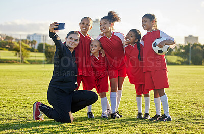Buy stock photo Soccer field, girl team and coach selfie for social media after training, competition and game together outdoors. Happy children, smile teacher and students community football academy taking photos