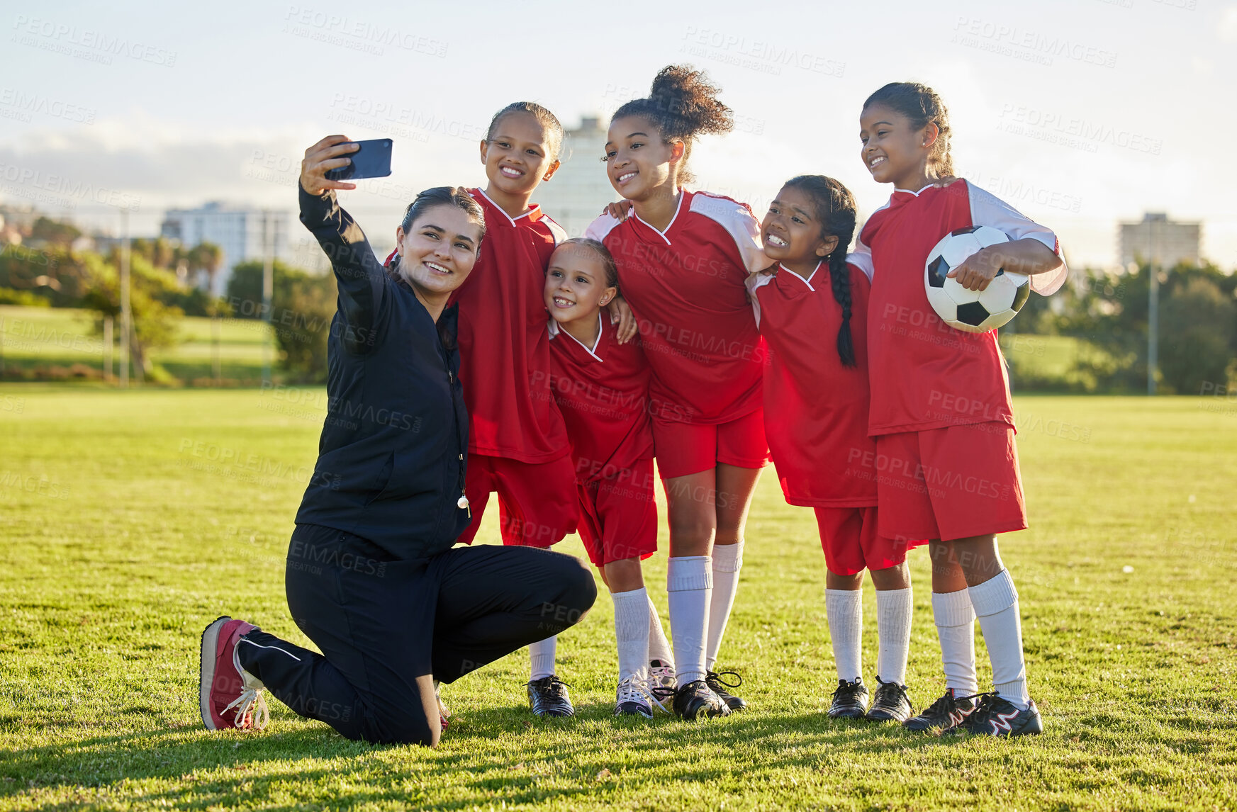 Buy stock photo Soccer field, girl team and coach selfie for social media after training, competition and game together outdoors. Happy children, smile teacher and students community football academy taking photos