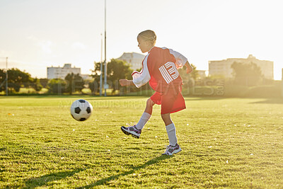 Buy stock photo Fitness, sport girl and soccer with football running, kick or exercise for match, training or workout on grass outdoor field. Healthy child, future soccer player or wellness goal, play sports game