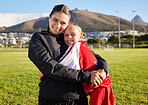 Woman football coach, girl soccer player hug on home field and celebrate child sports game win. Teamwork, athletic fitness and tactical strategy with passion or motivation lead to winning competition