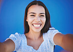 Portrait of girl taking a selfie with blue background and smile on face. Mockup for summer, fashion and beauty with happy, smiling and young woman with natural beauty taking a photo and having fun