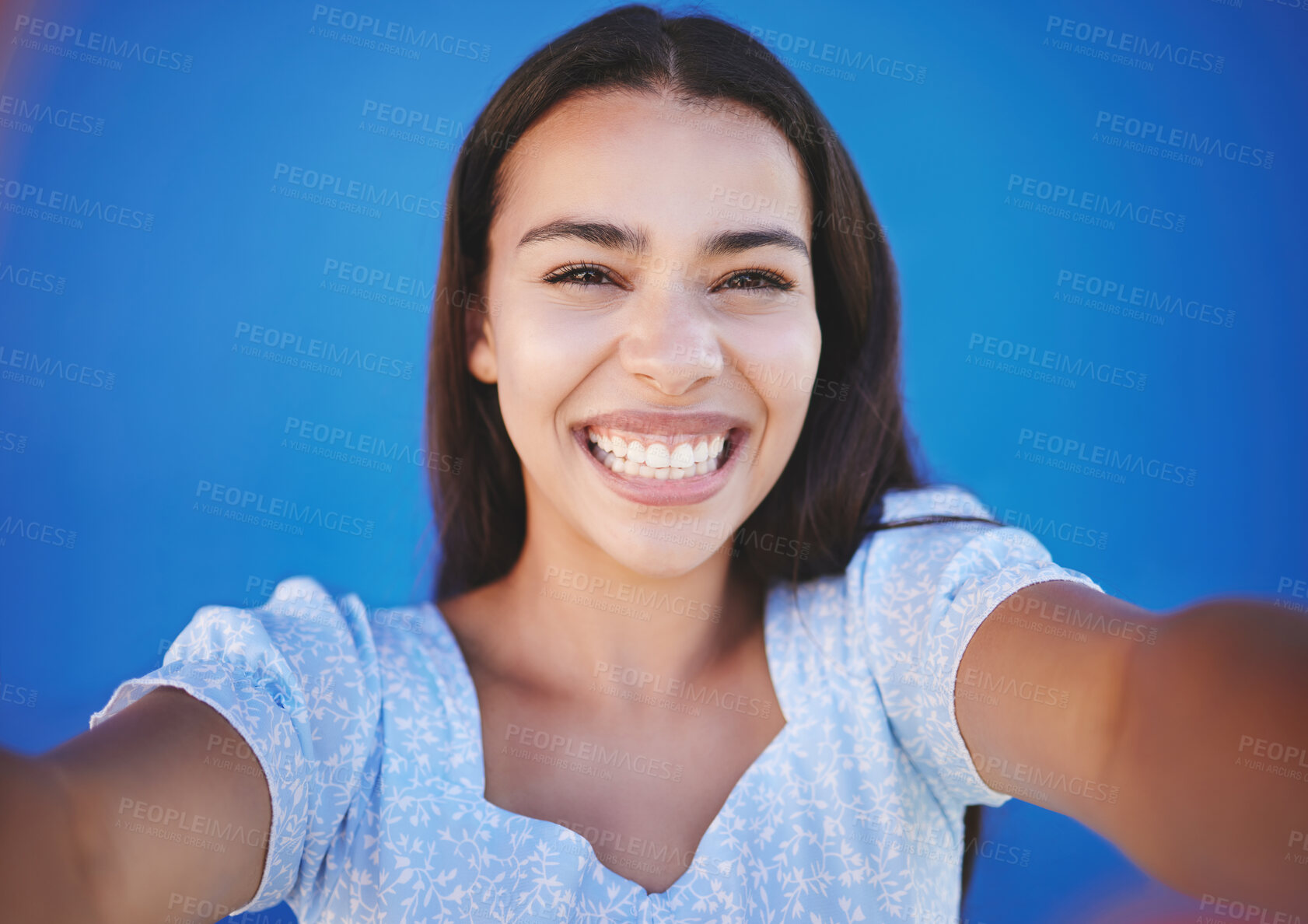 Buy stock photo Portrait of girl taking a selfie with blue background and smile on face. Mockup for summer, fashion and beauty with happy, smiling and young woman with natural beauty taking a photo and having fun