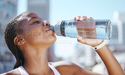 Buy stock photo Water bottle, fitness and black woman outside in city for exercise, training and a run for, health wellness and hydration during a workout. Fit athlete female feeling thirsty and drinking pure drink