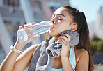 Fitness, woman and water drink for hydration in exercise, workout or training in the city outdoors. Active and athletic female runner drinking refreshing aqua liquid for healthy sports in nature