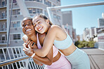 Fitness, city and hug from woman couple with exercise motivation, workout love and training wellness together in summer. Happy diversity sports friends or people exercise support or healthy lifestyle