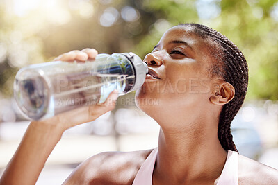 Buy stock photo Woman, exercise and drink water outdoor, while running or training in the summer. Lady, workout and bottle for hydration in the sun, runner in park with bottle for health, wellness and beauty
