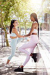 Fitness, health and friends stretching before outdoor run or cardio workout together in nature. Happy, motivation and interracial women outside for exercise with wellness, healthy and sport lifestyle