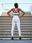 Exercise, workout and fitness black woman on a break at stairs after practice for health and wellness outdoor. Training, motivation or determined female with cardio routine for healthy or strong body