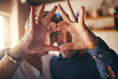 Buy stock photo Love, hands and heart sign with senior couple relax and bonding in their home together, cheerful and in love. Support, soulmate and loving man and woman sharing romantic moment and enjoy relationship