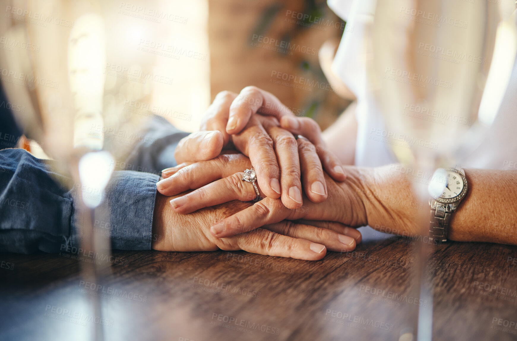 Buy stock photo Old couple holding hands, love and support on restaurant date, retirement and care together. Closeup senior man, elderly woman and life partner with hope, trust and kindness for marriage anniversary