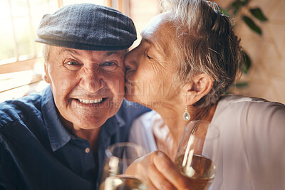 Buy stock photo Love, toast and old couple kiss with champagne in celebration of a happy marriage anniversary together at home. Smile, romance and senior woman enjoying a relaxing wine date and drink elderly partner