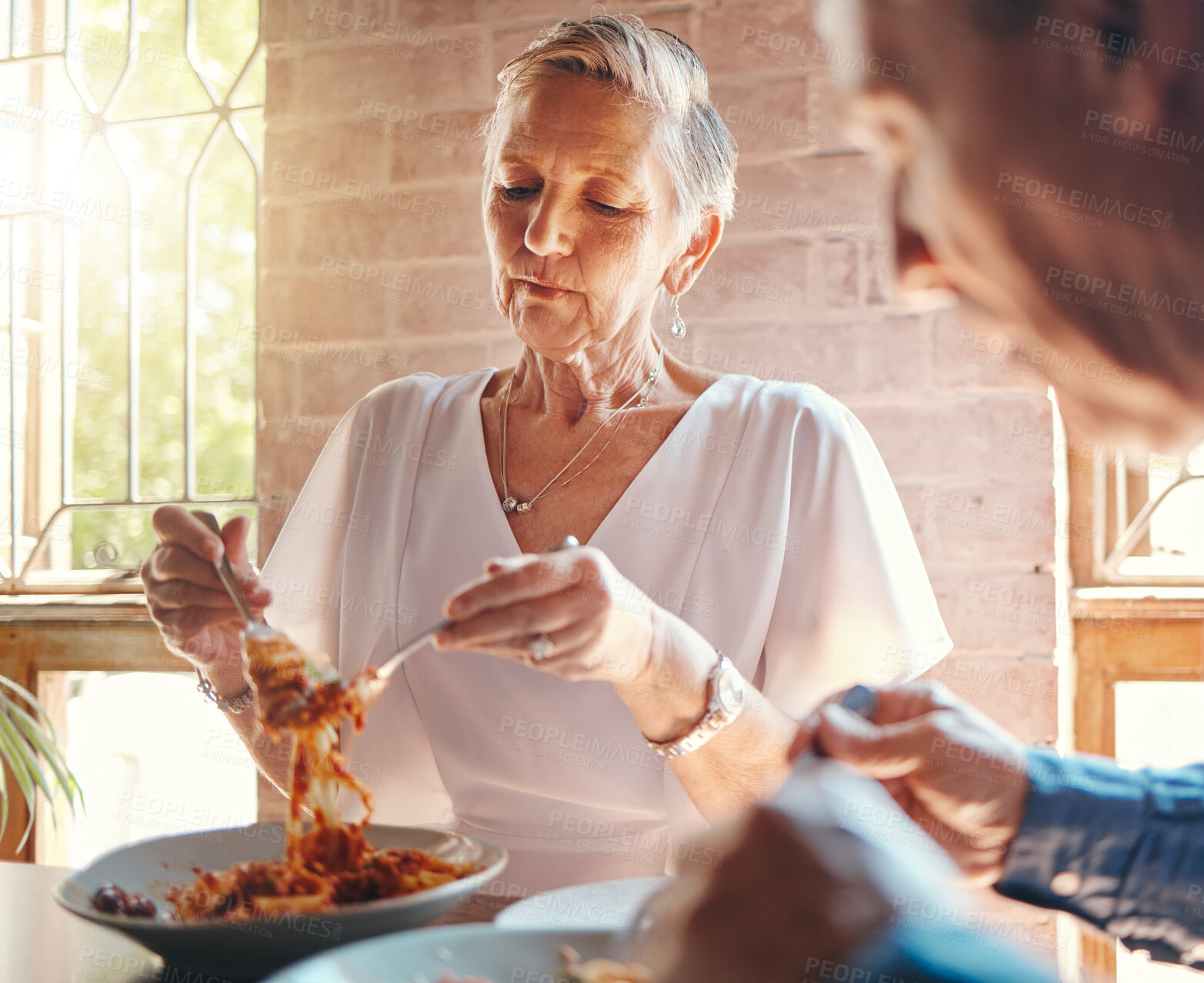 Buy stock photo Old couple eating pasta at restaurant together on a date celebrating anniversary. Food, romantic dinner and senior man and woman enjoying spaghetti in Italian diner for marriage and love celebration