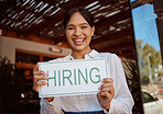 Recruitment, hiring sign and small business owner advertising a job at her coffee shop or restaurant. Entrepreneur, cafeteria and portrait of a happy business woman with vacancy board by cafe window.