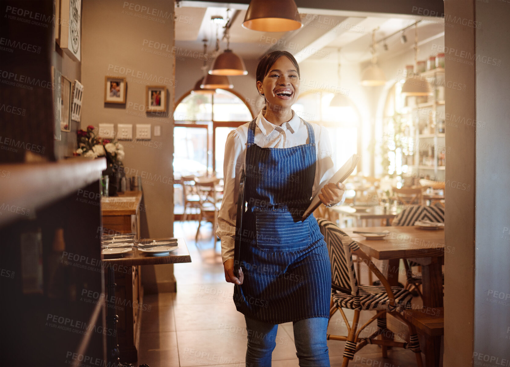 Buy stock photo Woman, happy and waitress in restaurant working in apron with food menu in hand for table. Girl, smile and service work at luxury diner, cafe or coffee shop show happiness on face for job in London