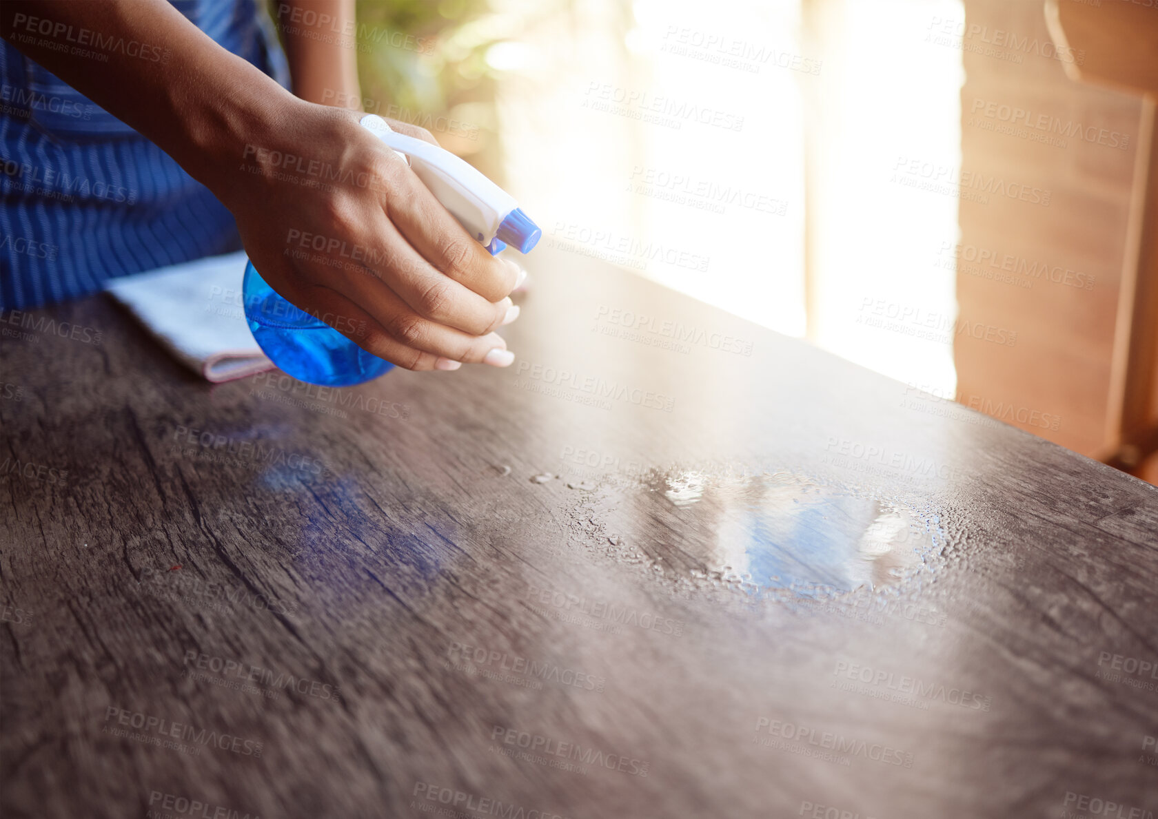 Buy stock photo Cleaner, hand and spray cleaning table with sanitizer in home, office or restaurant. Waitress, waiter and bottle with chemical to clean dirt, bacteria or covid 19 in cafe, house or coffee shop