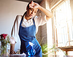 Cleaning house, burnout and tired cleaner working hard on dirty table and furniture feeling exhausted. Unhappy, frustrated and sweaty woman overworked in a difficult stressful job with daily pressure