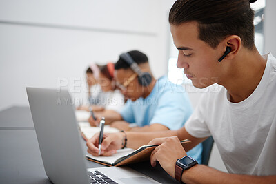 Buy stock photo Studying, notebook and laptop with students in university classroom, library or workspace for learning, education and exam. Young college people writing lecture notes, research and digital technology