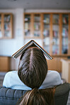 Burnout, tired and sleeping student with book on face in university library learning, education or reading problem. Fatigue, frustrated or bored college woman and research studying for language exam