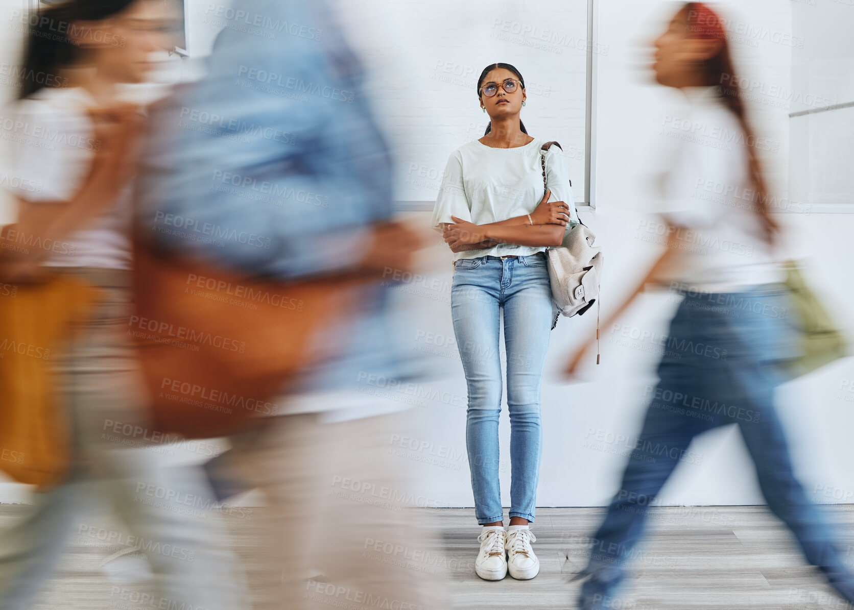 Buy stock photo Anxiety, fear and a woman in busy crowded university sad and thinking. Stress, doubt and depression, student in hallway before interview, exam or class. Motion blur, people and girl waiting in lobby.