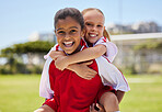 Portrait, friends and soccer player bonding at a field, having fun after sports game outdoors. Diversity, children and fitness hobby by girls embracing and laughing, playful and positive energy