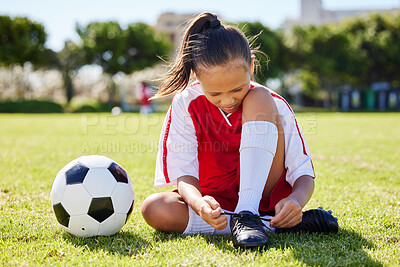 Buy stock photo Sports, soccer and tie shoes with girl on grass for fitness, games and training in brazil event. Motivation, workout and exercise with young child on football field for youth, health and wellness