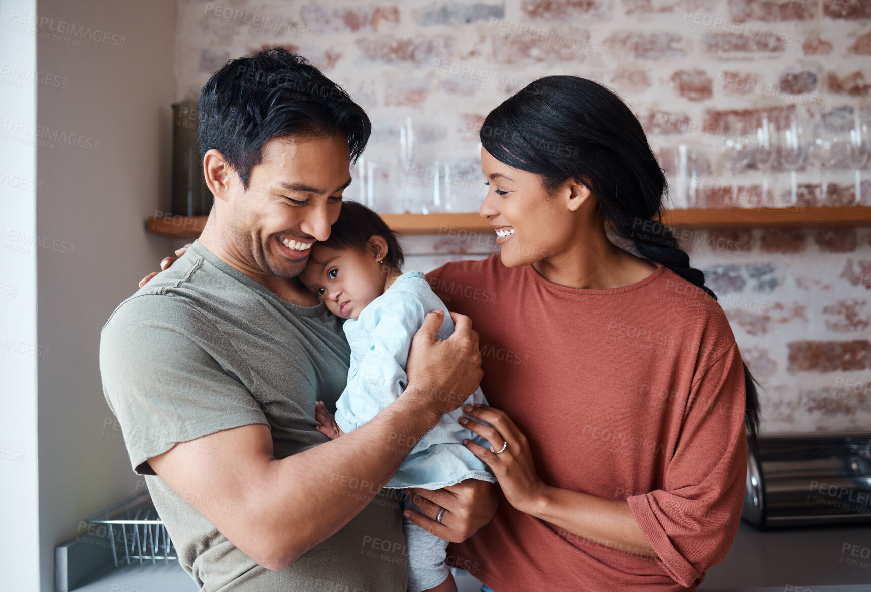 Buy stock photo Down syndrome, happy family and baby in a kitchen, bonding and embracing in their home together. Child development, love and special needs care for disability by asian parents enjoy morning indoors