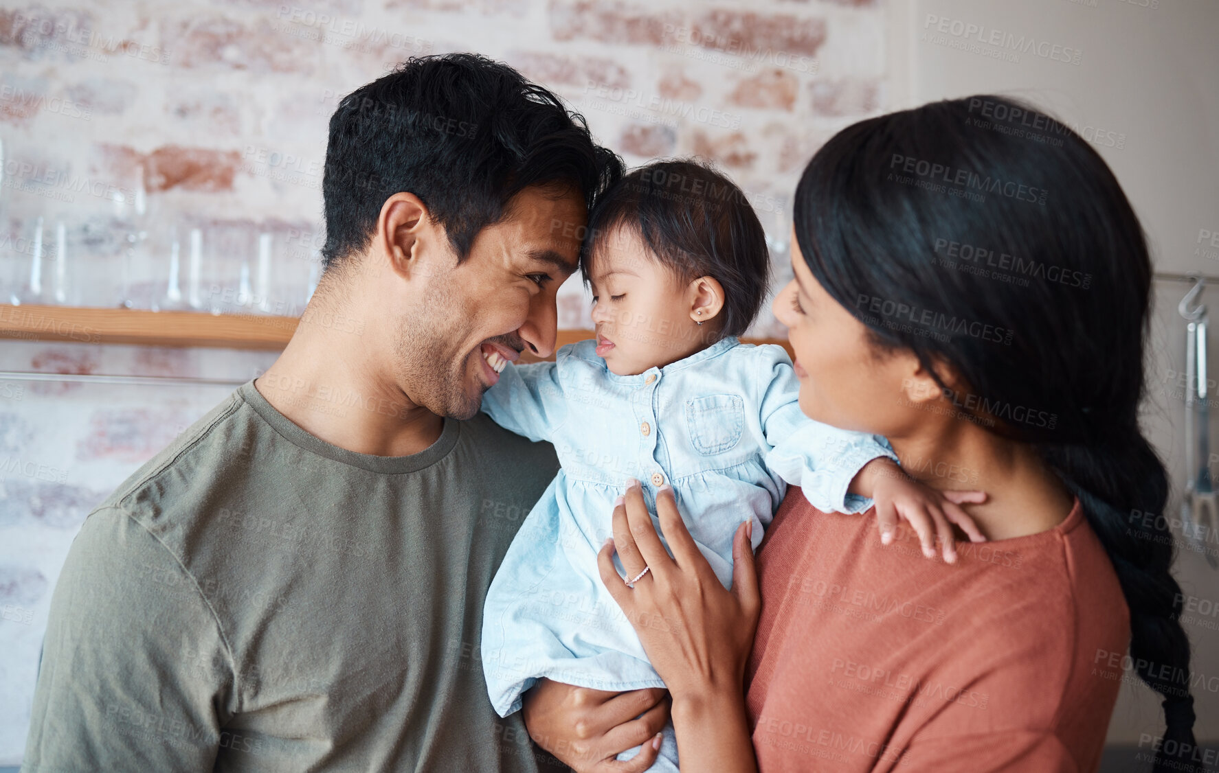 Buy stock photo Happy family, down syndrome baby and love in home, bonding and caring for infant child. Support, care and parents, father and mother spending time together with newborn girl with disability in house.