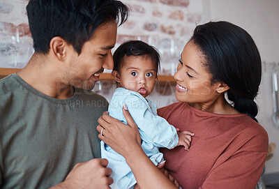 Buy stock photo Love, happy parents and baby with down syndrome in the kitchen embracing and bonding in their home. Happiness, smile and family care with special needs or disabled child standing together in a house.