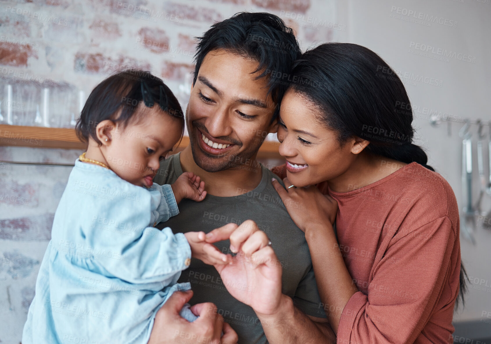 Buy stock photo Family with down syndrome baby, happy parents in kitchen home together and young child care. Indian father holding cute kid, asian mother smile with support and bonding happiness in Brazil house