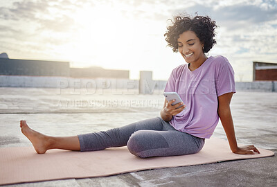 Buy stock photo Phone, social media and yoga with a woman athlete on a rooftop for fitness, workout and exercise in the city. Sports, communication and training with a zen female exercising outside in the day