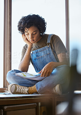 Buy stock photo Young woman, reading book and relaxing on a window sill looking calm, focus and peaceful at home. Smart female student studying literature or educational book in her free time in her cozy apartment
