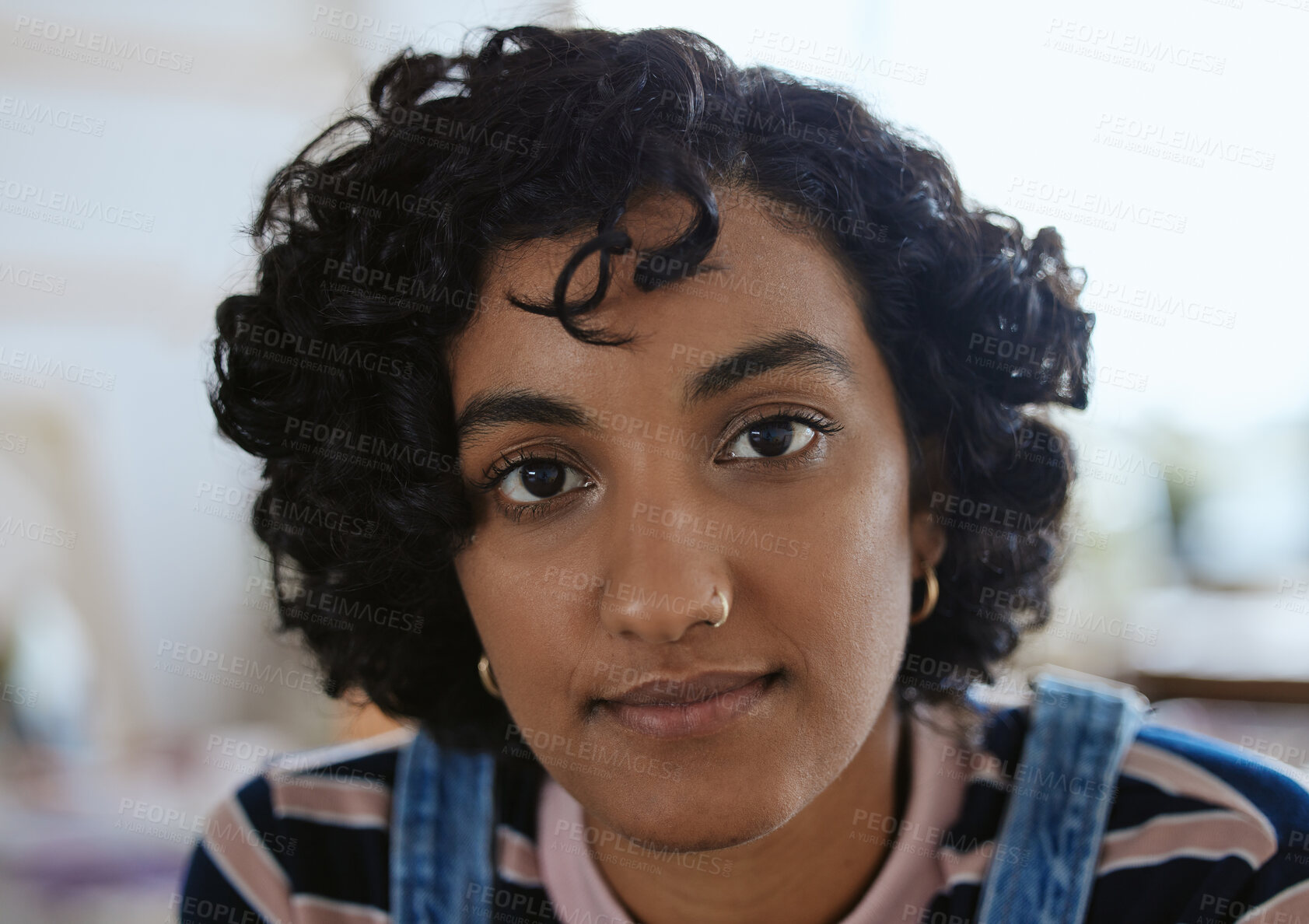Buy stock photo Face, eyes and portrait with a woman from India closeup inside with curly hair and a serious expression. Head, nosering and piercing with an attractive young female for edgy, trendy or modern style