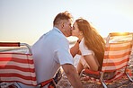 Couple, kiss and beach with a man and woman kissing while on a date together during summer. Romance, relationship and dating with a male and female in celebration of their honeymoon or anniversary