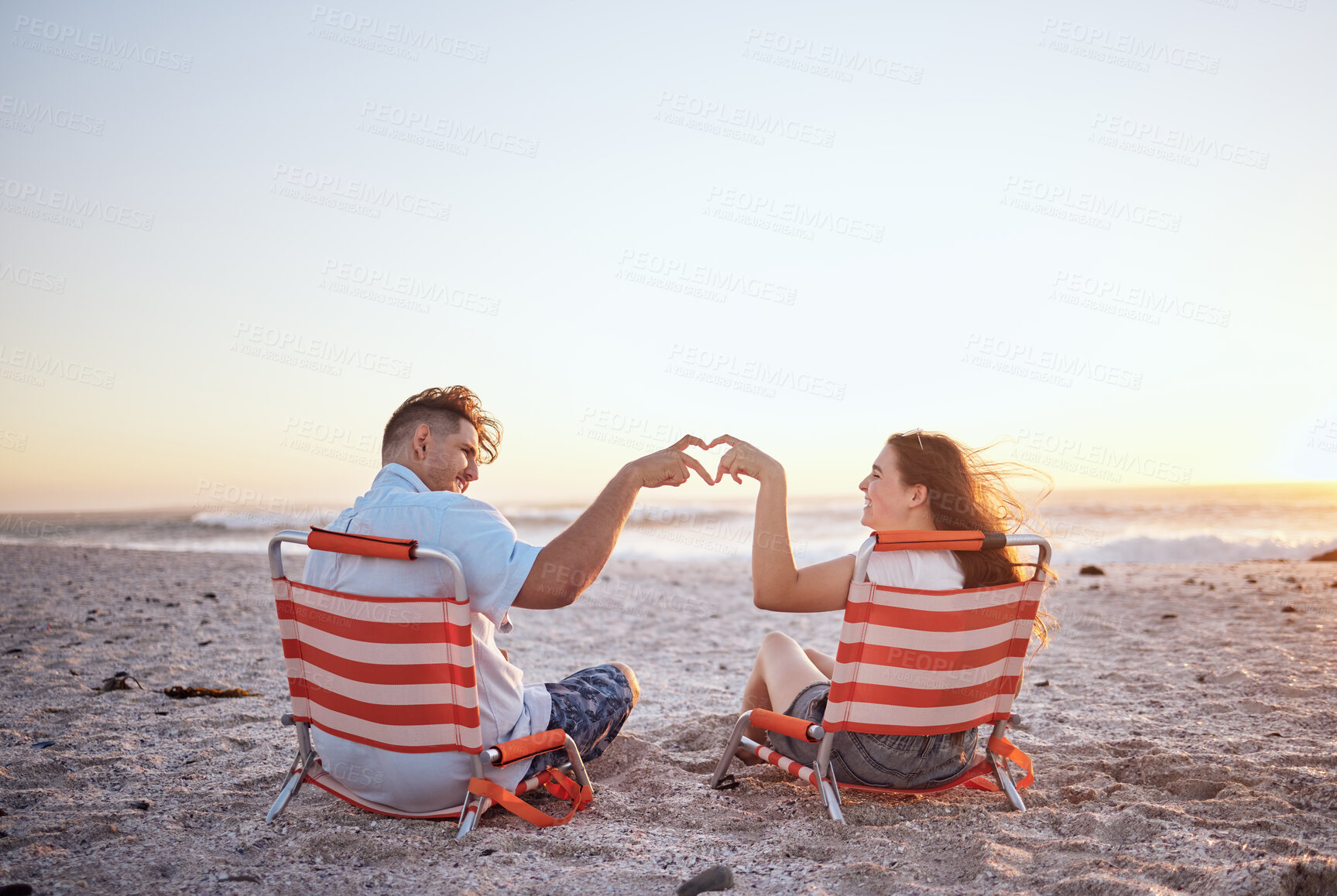 Buy stock photo Beach, heart sign and couple with love in summer and ocean on sunset sky and happy. Mockup space of man, woman or gen z people with hands, icon or emoji for outdoor summer vacation or romantic date 