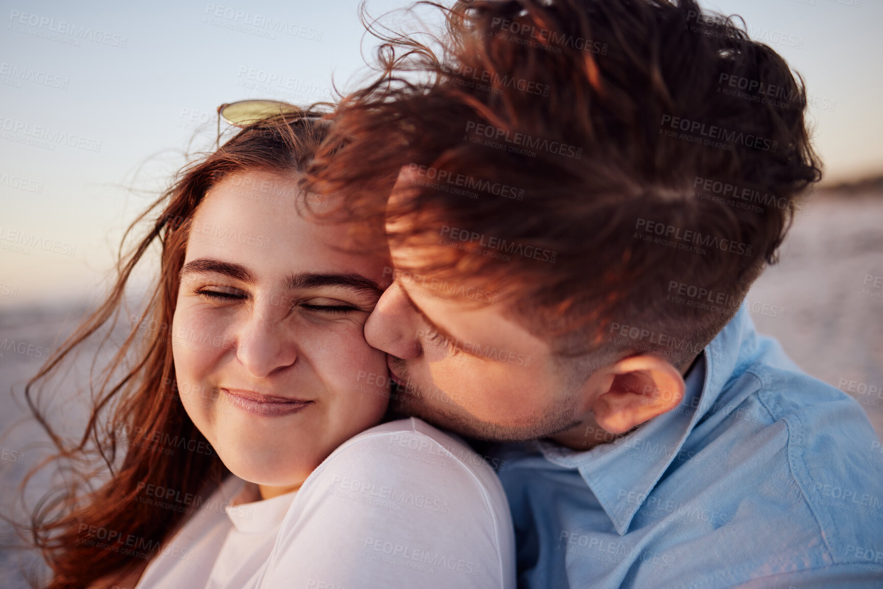 Buy stock photo Face, love and couple cheek kiss on vacation, holiday or summer trip outdoors. Romance, affection and man, woman and bonding, spending quality time together and happy romantic smile on date outside.