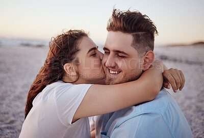 Buy stock photo Love, couple and kiss on beach happy to celebrate relationship with sunset being relax, smile and on holiday. Romance, man and woman hug, embrace and bonding on seaside vacation together outdoor. 