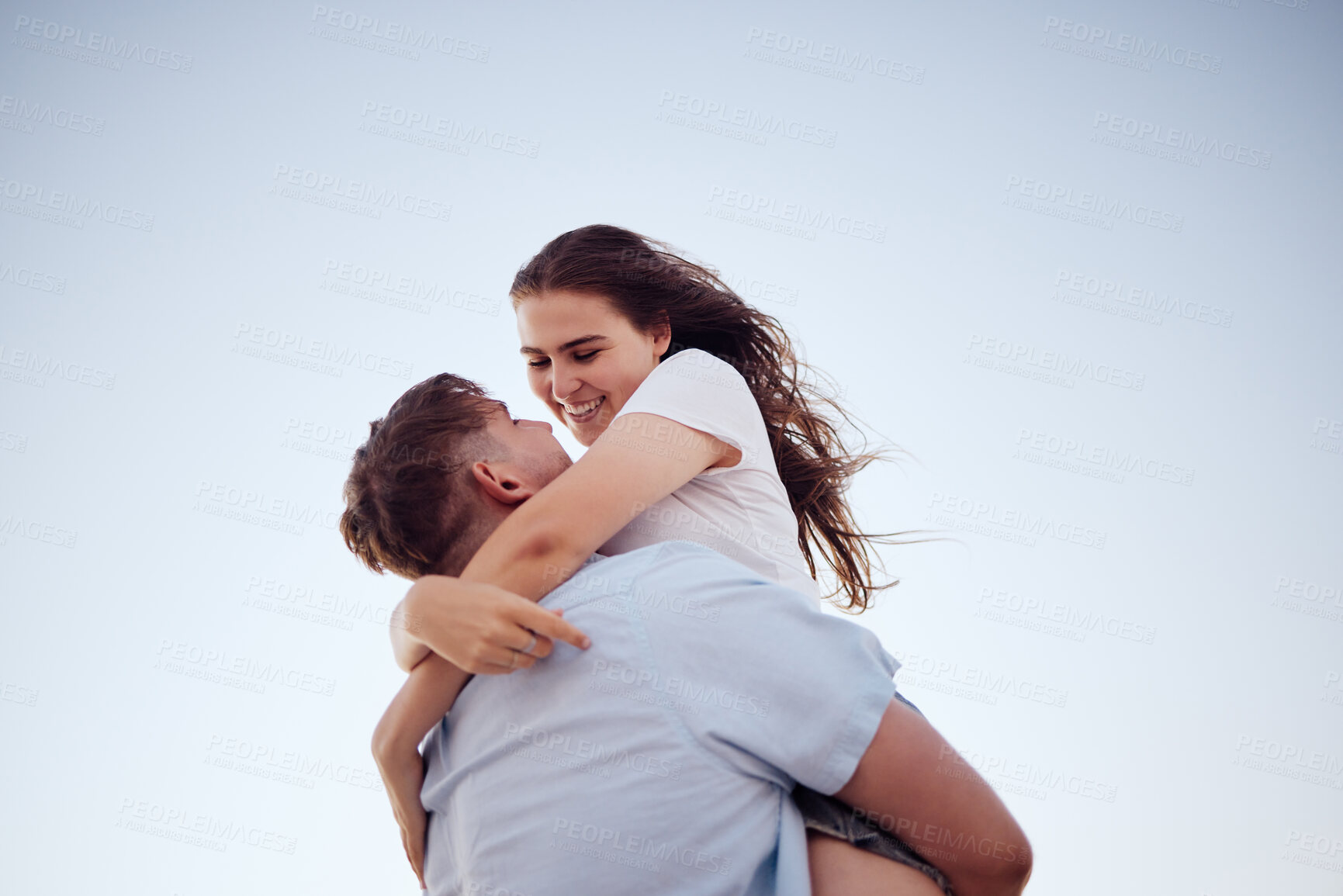 Buy stock photo Hug, happiness and love of a couple together in an embrace with a smile in summer. Happy girlfriend and boyfriend feeling relationship gratitude spending quality time with a blue sky background 