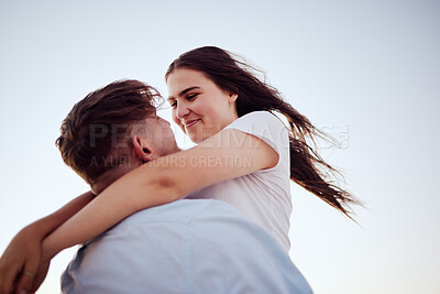 Buy stock photo Happy, couple and love hug for real joy in happiness for bonding relationship and travel in the outdoors. Man lifting woman in loving embrace for romance with smile on summer vacation together