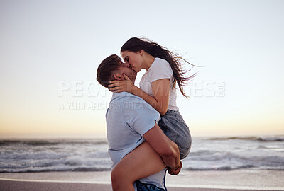 Buy stock photo Love, couple and kiss on beach at sunset for romantic and passionate embrace on summer evening date. Dating USA woman and man enjoy dusk sky together at Los Angeles ocean with physical affection.
