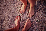 Couple, feet and beach on wet sand for calm, relax and travel on summer vacation together in nature. Toes of people in relationship on sandy ocean for holiday traveling in the outdoors of Costa Rica