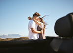 Couple, love and kiss on nature road trip, vacation or summer holiday outdoors in Canada. Romance, affection and happy man, woman and hug spending quality time together, bonding and kissing by car. 
