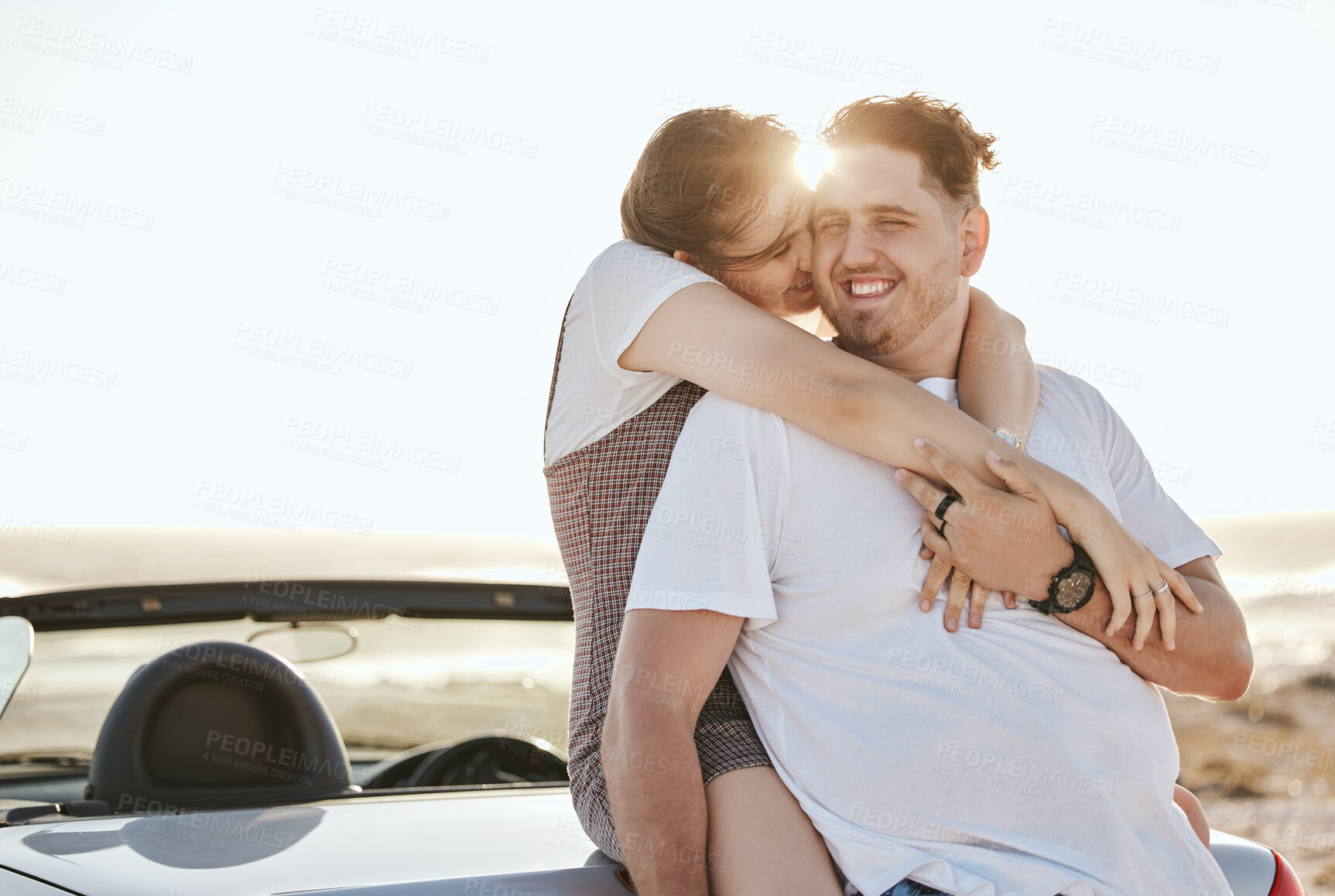 Buy stock photo Road trip, couple and travel with a man and woman on vacation with a car in nature at sunrise. Love, happy and transport with a young male and female hugging while on holiday together in summer