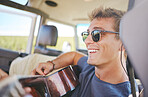 Music, guitar and young man in car on a roadtrip adventure in nature. Summer, holiday and journey on the road, having fun on vacation. Travel, freedom and explore nature with musical instrument