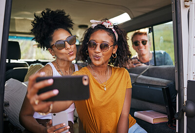 Buy stock photo Selfie, phone and road trip with girl friends taking a photograph while sitting in a car or van on vacation. Mobile, social media and transportation with a female and friend posing for a picture